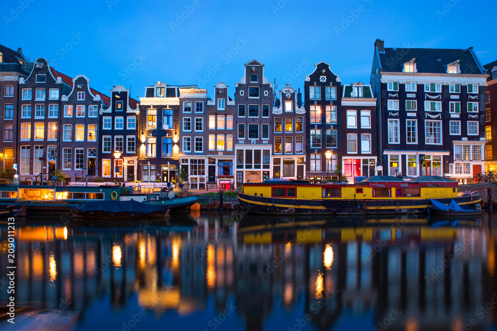 Obraz na płótnie Amsterdam canal  with typical dutch houses and houseboats at evening with beautiful water reflections, Holland, Netherlands.  w salonie