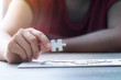 © Kaikoro - Close up shot hands of woman holding paper jigsaw puzzle select focus shallow depth of field