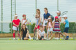 © master1305 - Portrait of group of girls as tennis players holding tennis racket against green grass of outdoor court