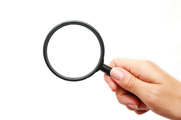 Female hand with a magnifying glass on a white background