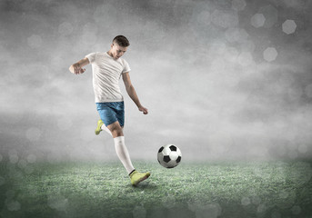 Soccer player on a football field in dynamic action at summer day