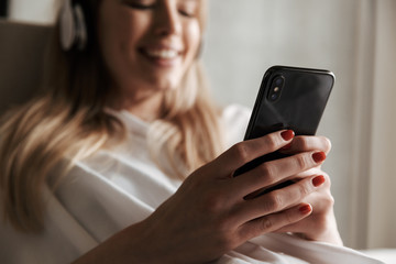 Wall Mural - Close up of cheerful woman in headphones