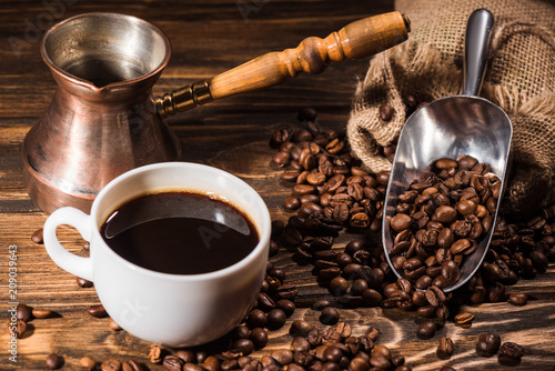 Fotografie, Obraz close-up shot of cup of coffee with roasted beans and cezve