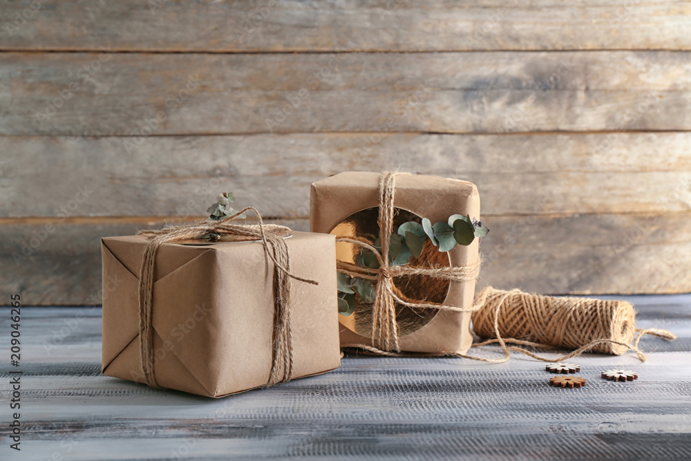 Stylish gift boxes on wooden background