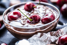 Fresh Cherries In Bowl With Chocolate On Dark Tablecloth