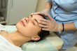 © Alexandr - beautiful young girl on a facial treatment in a beauty salon doing face massage