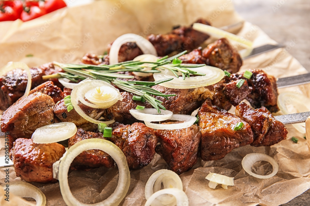 Barbecue skewers with juicy meat on table
