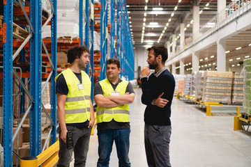 Wall Mural - Manager talking with employees in warehouse