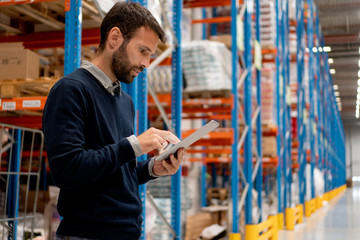 Sticker - Manager holding digital tablet in warehouse