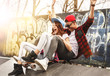 © BalanceFormCreative - Young teen couple sitting on ramp and hangout at the skate park .Laughing and fun.