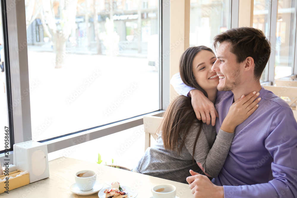 Happy couple having romantic date in cafe