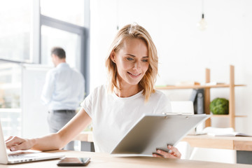 Wall Mural - Smiling woman manager working on laptop computer