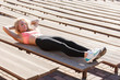 © snedorez - Picture of sports woman exercising among benches in summer day