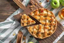 Wooden Board With Tasty Apple Pie On Table