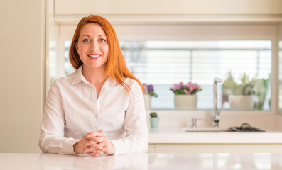 Canvas Print - Redhead woman at kitchen with a happy and cool smile on face. Lucky person.