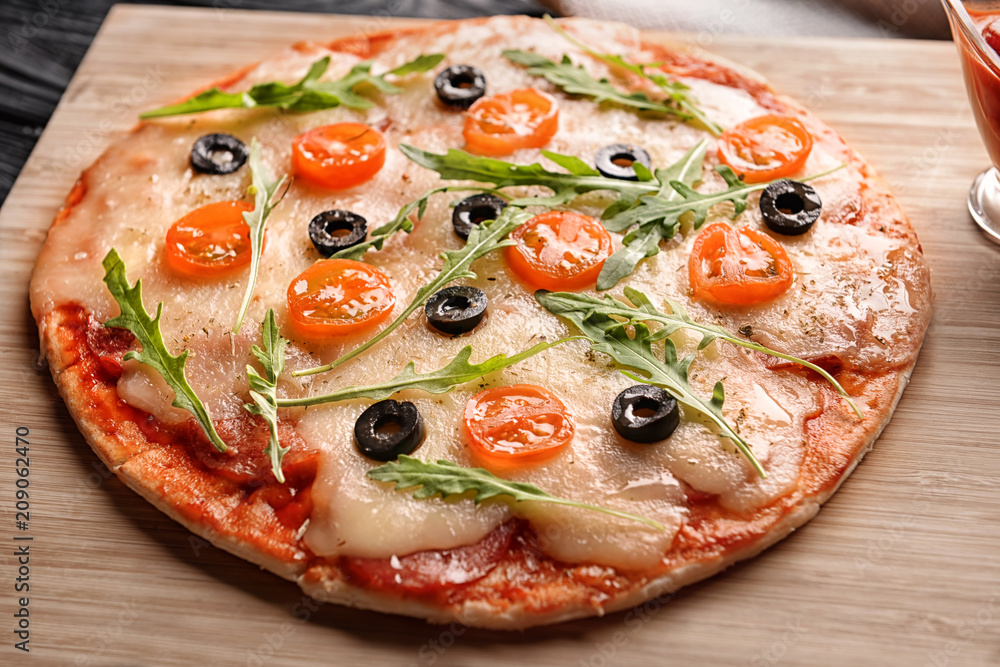 Tasty pizza on wooden board