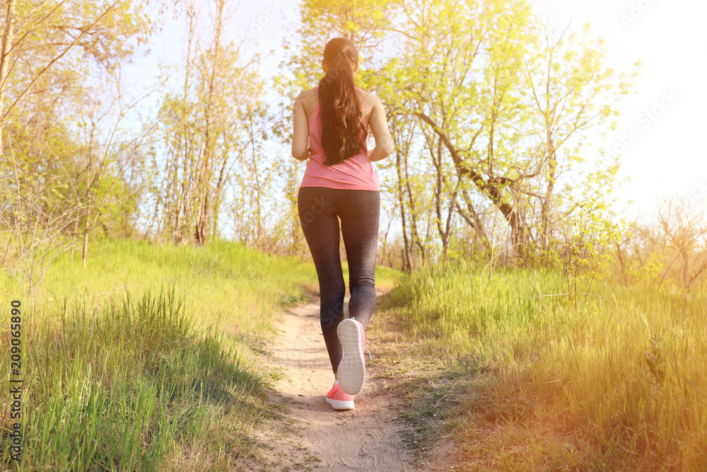 Sporty young woman running in park