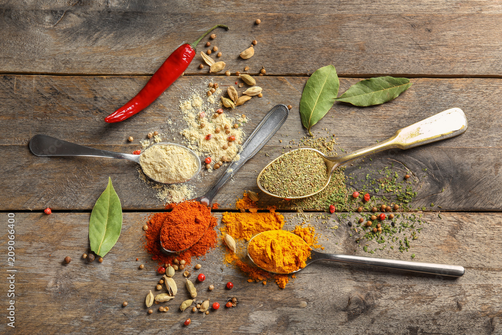 Composition with different spices on wooden background