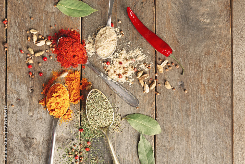 Composition with different spices on wooden background
