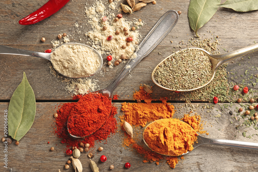 Composition with different spices on wooden background