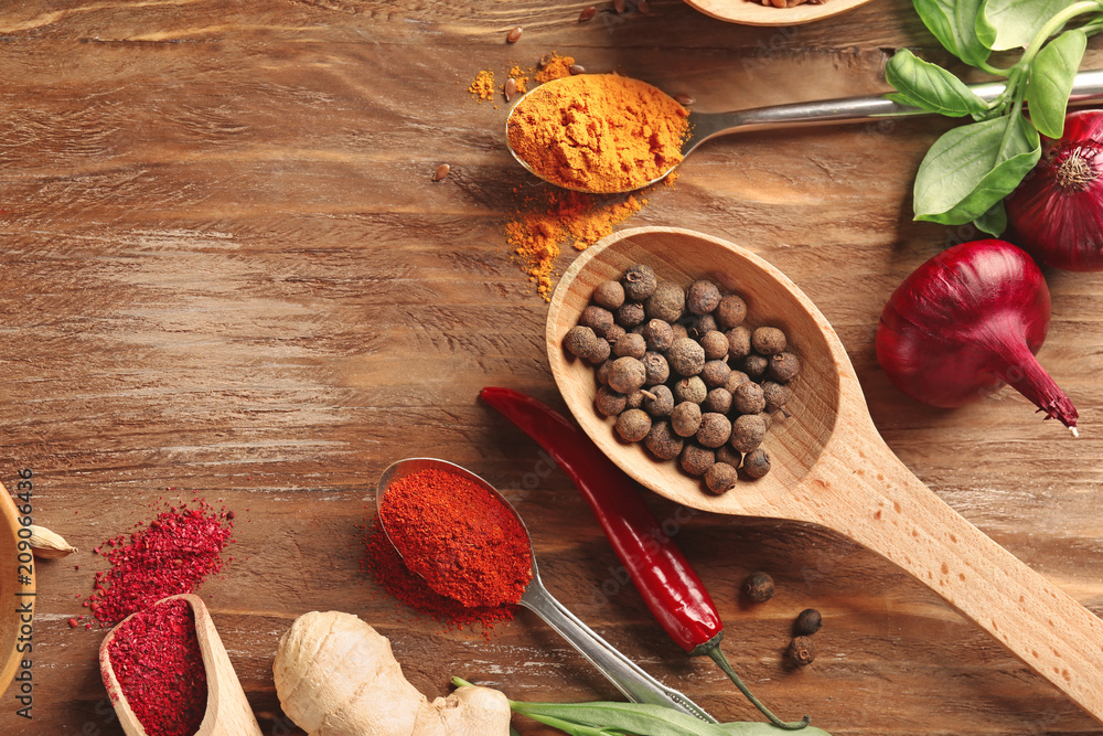 Composition with different spices on wooden background