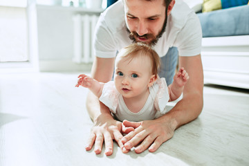 father and his baby daughter at home