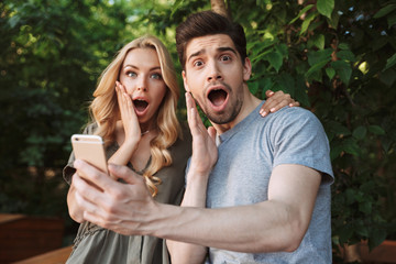 Sticker - Surprised young couple taking a selfie together