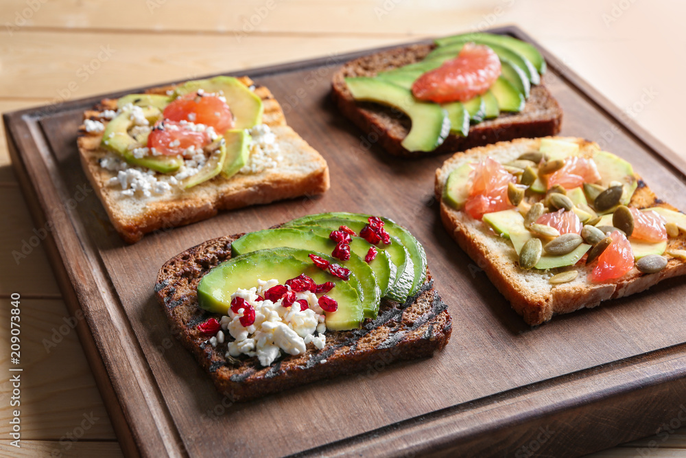 Tasty toasts on wooden board