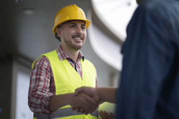 Engineer and customer shaking hands having agreement success in working site.