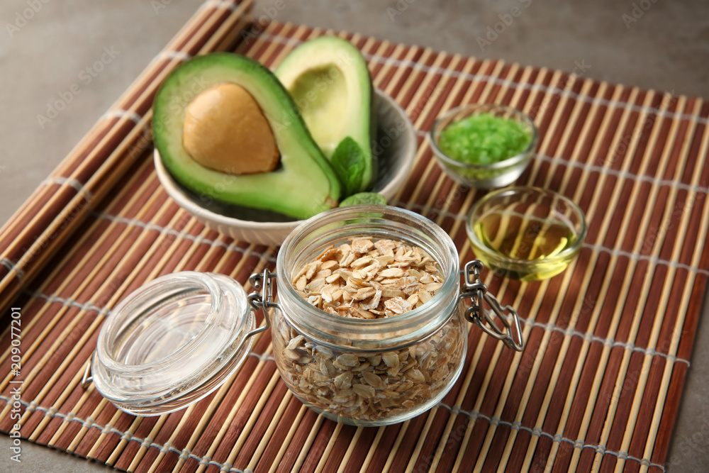 Avocado with ingredients for natural homemade cosmetics on bamboo mat