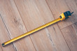 © andrey gonchar - Construction tape measure on a wooden floor