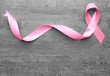 © Pixel-Shot - Pink ribbon on grey background. Breast cancer concept