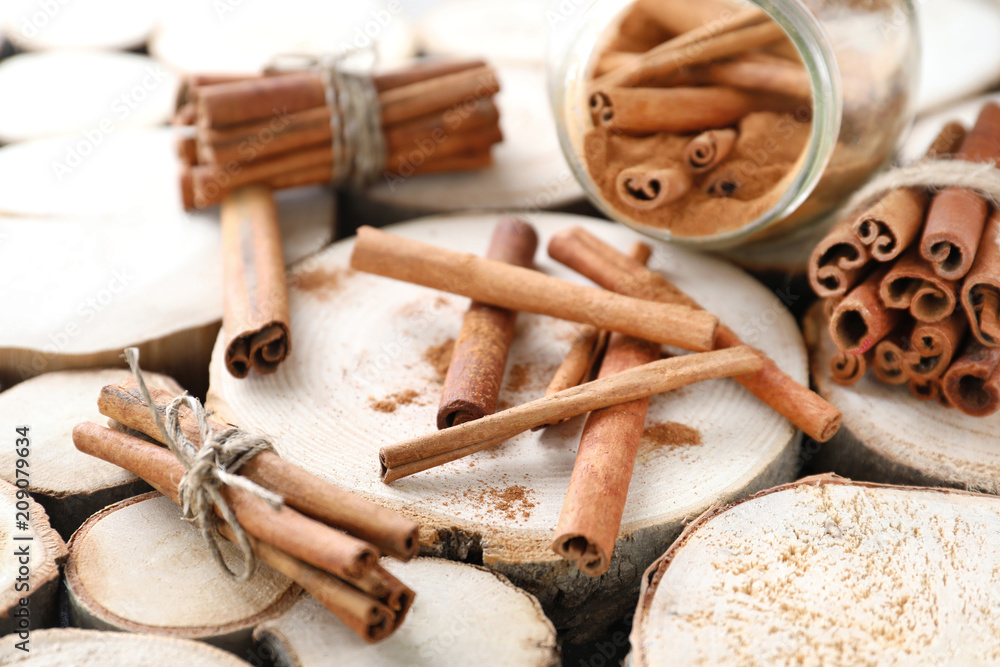 Composition with cinnamon sticks on wooden background