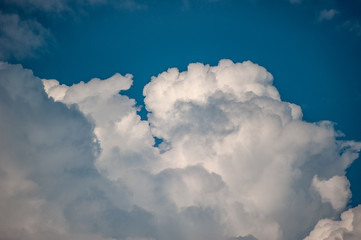 Huge fluffy clouds on the blue sky