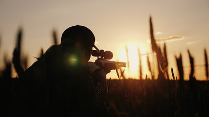 a sniper rifles from a rifle with an optical sight. on the sunset. sports shooting and hunting conce