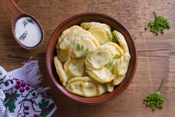 Wall Mural - Dumplings, filled with cottage cheese (farmer cheese). Varenyky, vareniki, pierogi, pyrohy. View from above, top studio shot