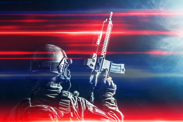 Wall Mural - Special forces soldier with rifle on dark background