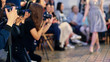 © Denys Kurbatov - Closeup of photographers working on presentation of modern fashion show