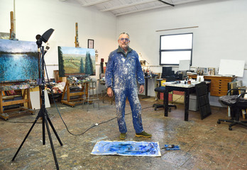 portrait of a painter artist who works in his studio