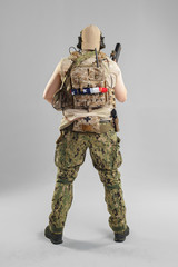 Wall Mural - Special forces soldier with rifle on white background.