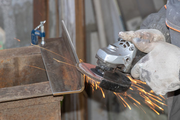 Work sanding metal. Grinding metal grinder. Sparks when grinding metal.