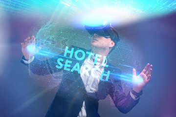 Wall Mural - Business, Technology, Internet and network concept. Young businessman working in virtual reality glasses sees the inscription: Hotel search