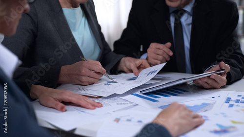 Fotografía Government officials discussing import and export report diagrams, research