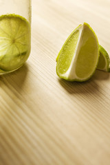 Wall Mural - slices of lime on a wooden table with copy space