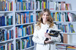 © blicsejo - Beautiful female student in a university library