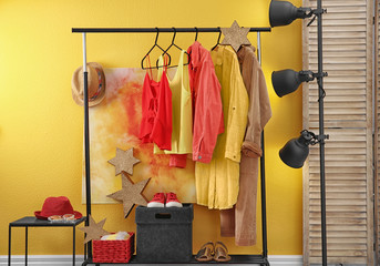 Poster - Stylish dressing room interior with clothes on rack