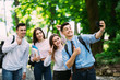 Young happy cheerful students making selfie in campus outdoors
