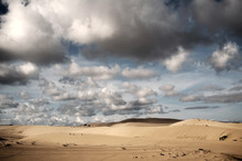 Cloudy Sky Over Tranquil Sand Dunes