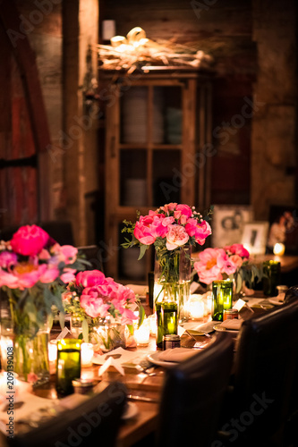 Table In Dark Room Decorated With Pink Roses Peonies And