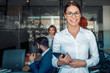 © ivanko80 - Business woman using tablet in front of her colleagues in the office